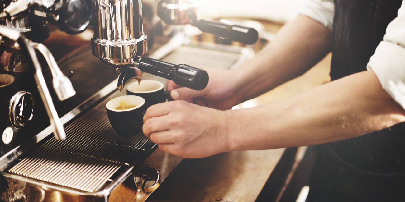 barista using espresso machine